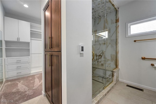 bathroom featuring a shower with door