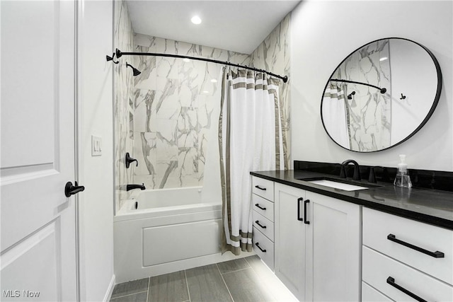 bathroom featuring vanity and shower / bath combination with curtain