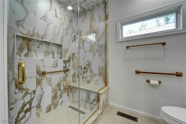 bathroom featuring tile patterned flooring, an enclosed shower, and toilet