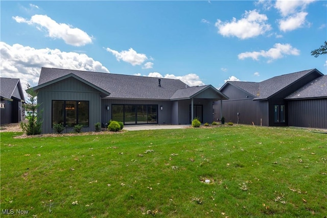 back of house with a yard and a patio area