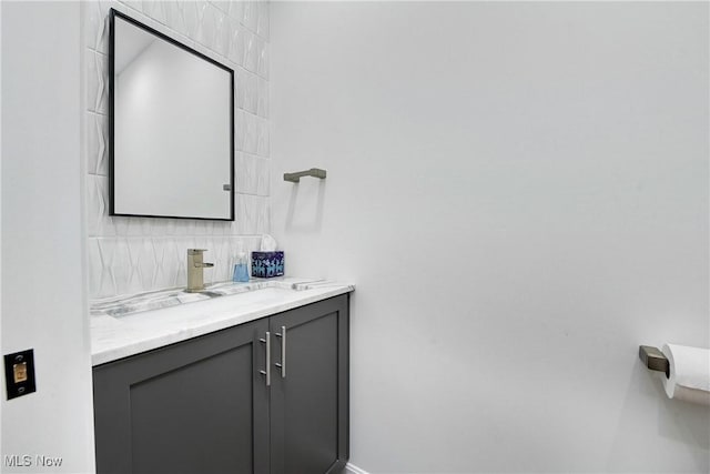 bathroom featuring vanity and decorative backsplash