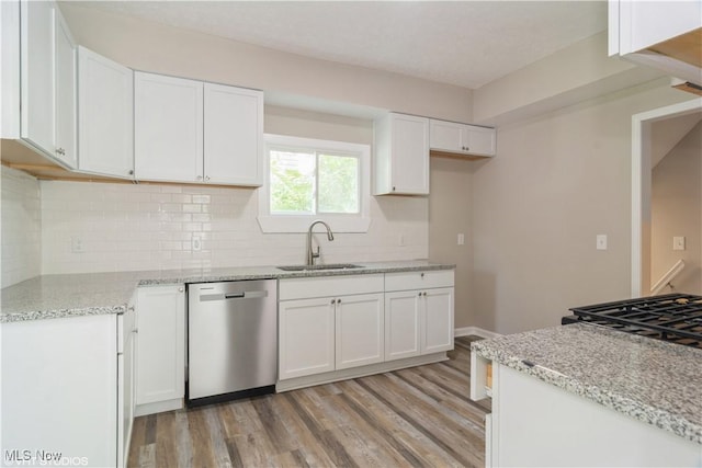 kitchen with white cabinetry, dishwasher, and a sink