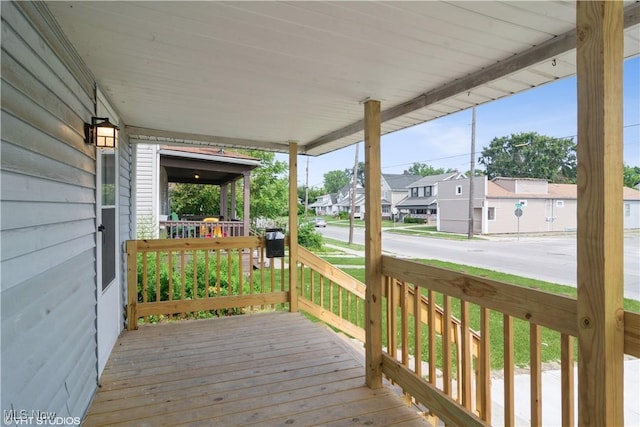 wooden deck featuring a residential view and a porch