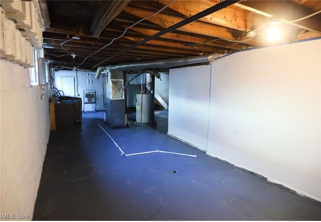 basement with washer / dryer, gas water heater, and heating unit