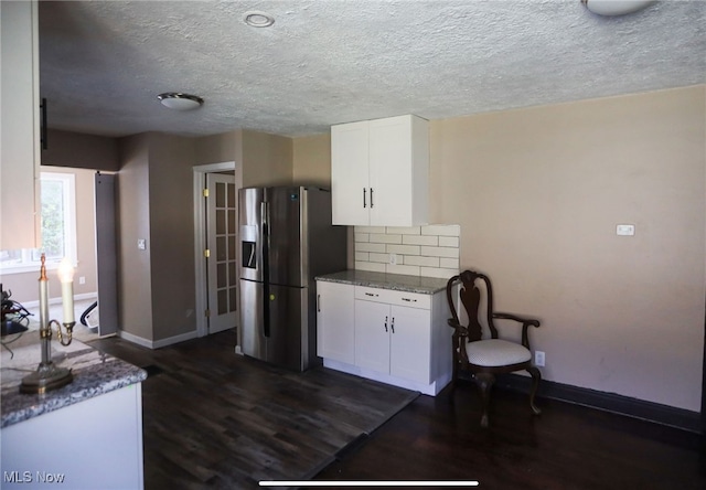 kitchen featuring stainless steel fridge with ice dispenser, dark wood-type flooring, and white cabinetry