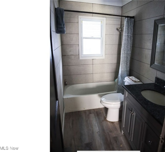 full bathroom featuring shower / tub combo with curtain, vanity, toilet, and hardwood / wood-style flooring