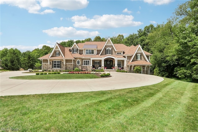 craftsman-style home with a front yard