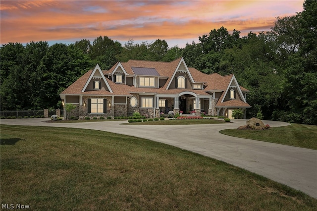 craftsman-style home featuring a lawn