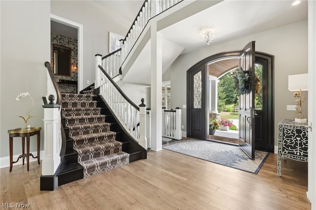 foyer with lofted ceiling and wood-type flooring