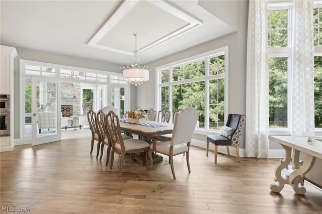 sunroom / solarium featuring a chandelier and a wealth of natural light