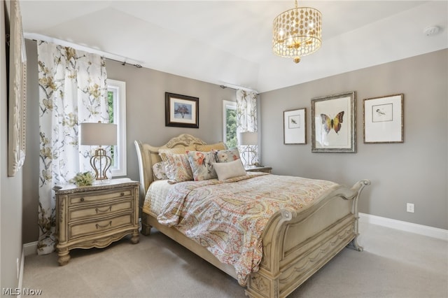 bedroom featuring light colored carpet and an inviting chandelier