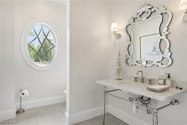 bathroom featuring tile patterned floors, vanity, and toilet