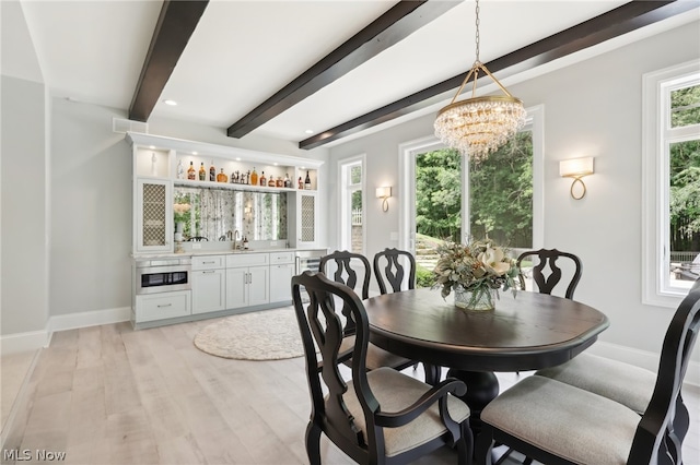 dining area featuring beam ceiling, light wood-type flooring, and a chandelier