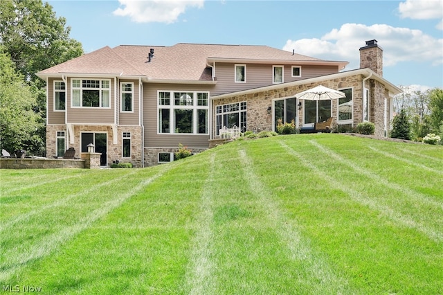 rear view of property featuring a yard