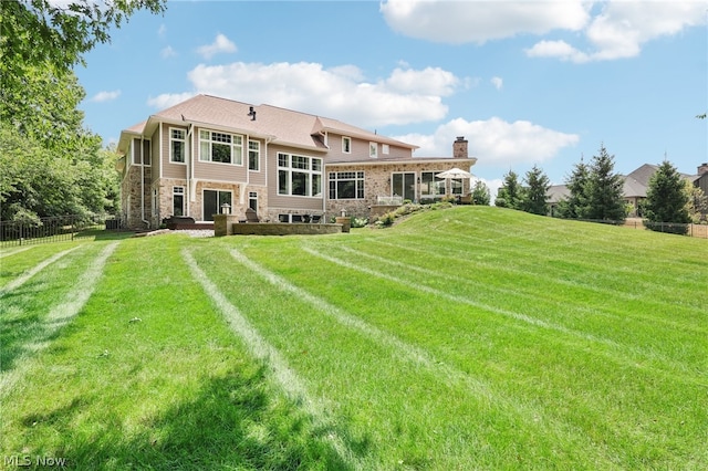 back of house featuring a lawn