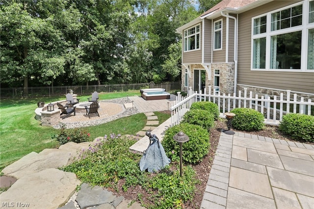 view of yard featuring a fire pit, a patio area, and an outdoor hot tub