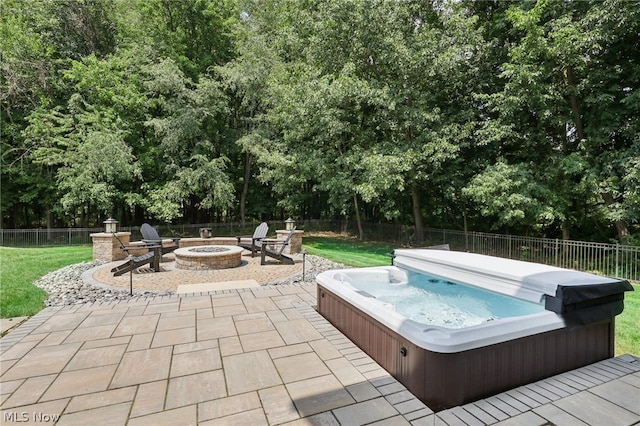 view of swimming pool featuring a patio area, a fire pit, and a covered hot tub