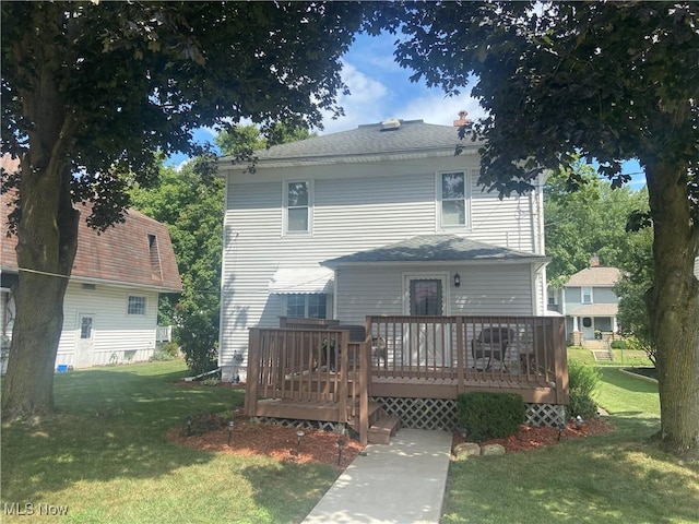 back of house featuring a yard and a deck