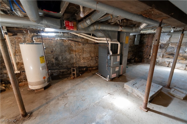 basement with electric panel, heating unit, and gas water heater