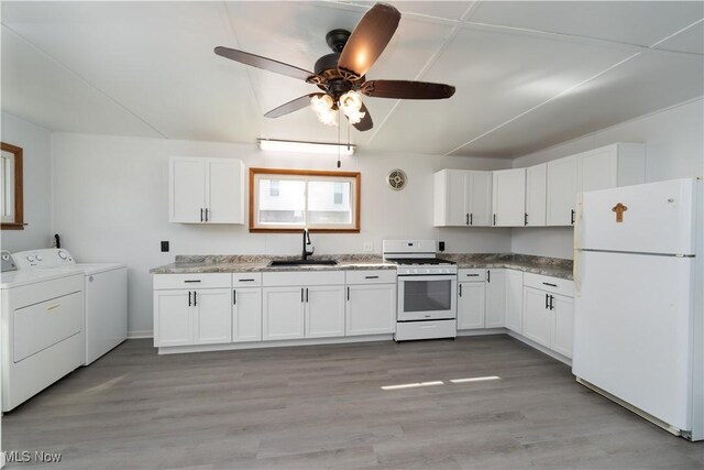 kitchen with washer and dryer, ceiling fan, light hardwood / wood-style floors, white appliances, and sink