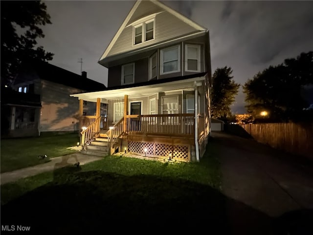 front of property featuring covered porch and a front yard