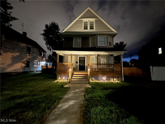 view of front of house with a front yard and covered porch