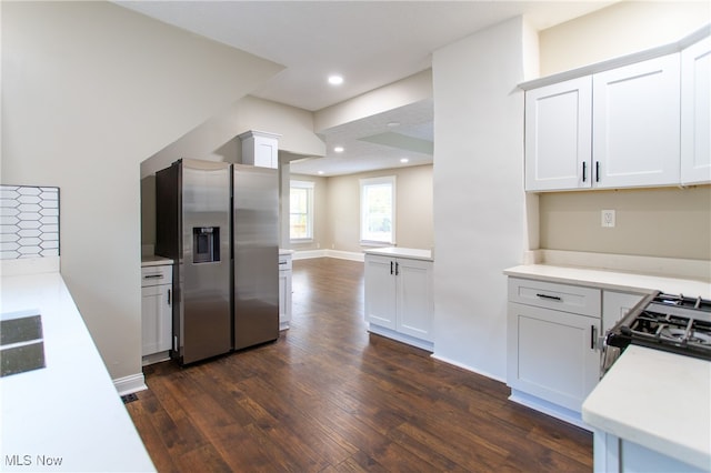 kitchen featuring white cabinetry, appliances with stainless steel finishes, and dark hardwood / wood-style flooring