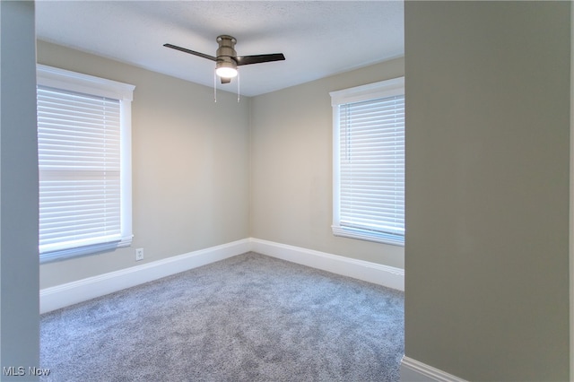 empty room featuring carpet floors and ceiling fan