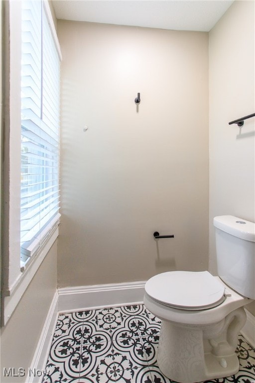 bathroom featuring toilet and tile patterned flooring