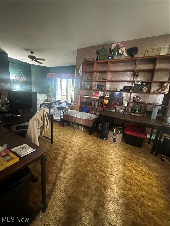 interior space featuring carpet and ceiling fan