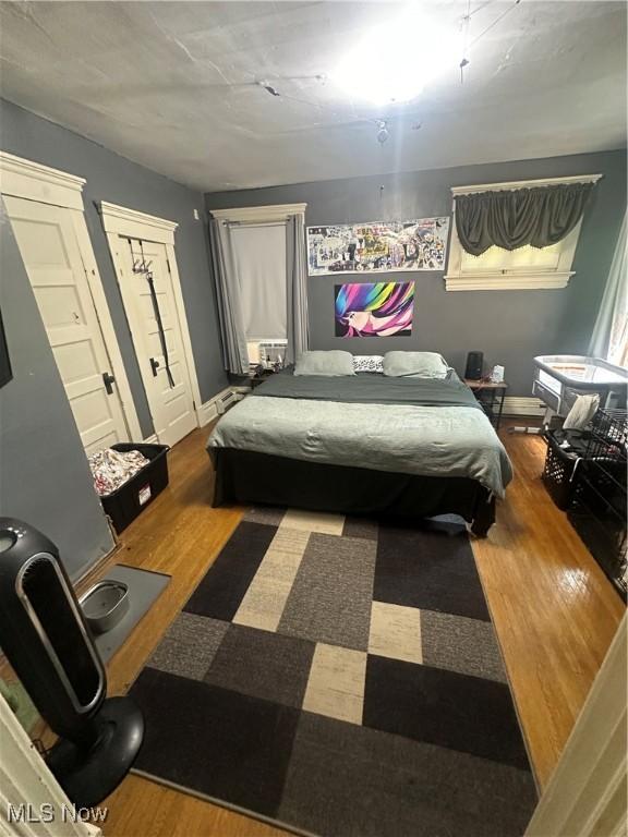 bedroom with pool table and hardwood / wood-style flooring