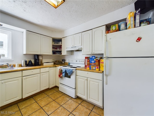 kitchen featuring white appliances, a textured ceiling, light tile patterned flooring, white cabinetry, and sink