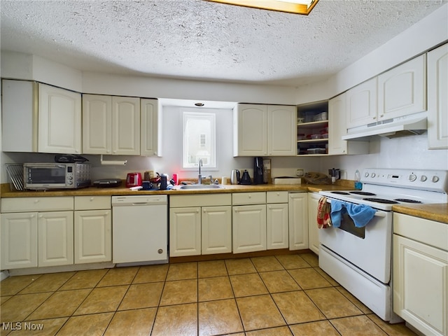 kitchen with white appliances, sink, a textured ceiling, and light tile patterned floors