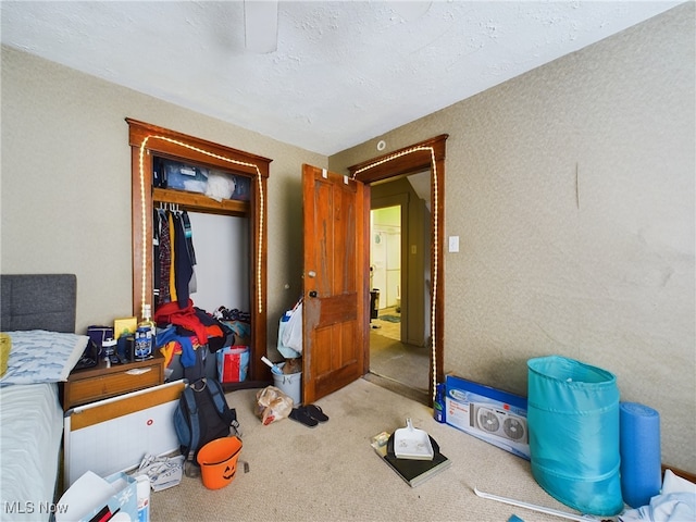 bedroom with a textured ceiling and carpet floors