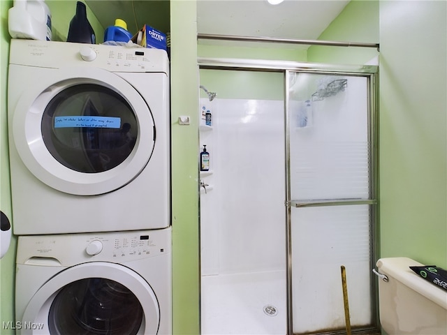 clothes washing area featuring stacked washing maching and dryer