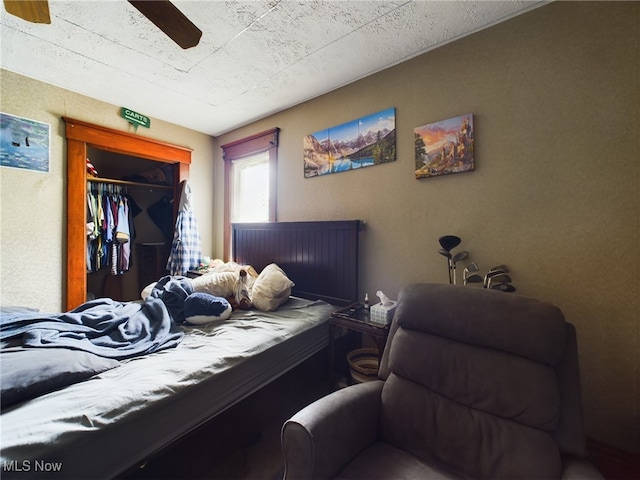 bedroom with ceiling fan and a closet