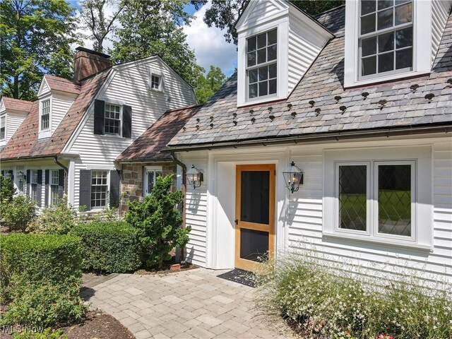 cape cod house featuring a patio