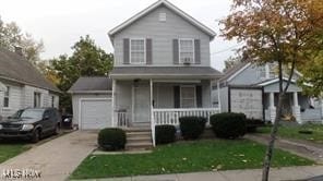 view of property featuring a porch and a garage