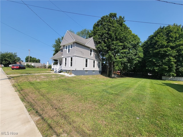 view of side of home with a lawn