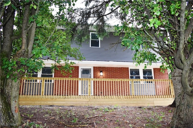 back of house with a wooden deck