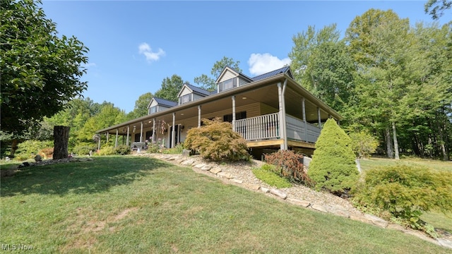 back of house with a lawn