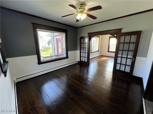 unfurnished room featuring french doors, wood-type flooring, a baseboard radiator, and a healthy amount of sunlight