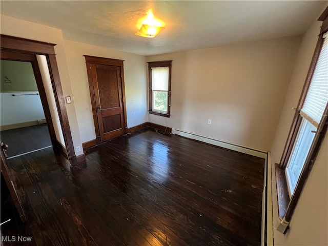 unfurnished bedroom with dark hardwood / wood-style floors and a closet