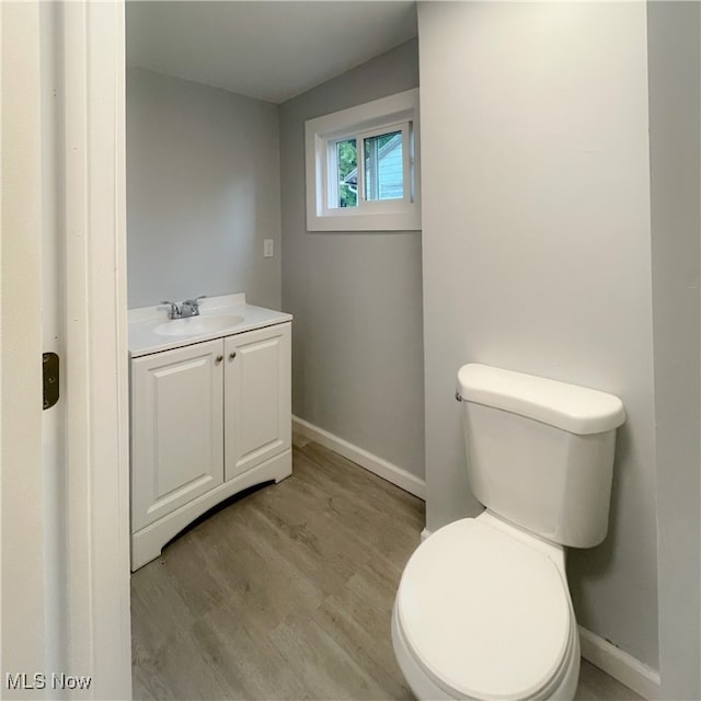 bathroom featuring hardwood / wood-style floors, toilet, and vanity