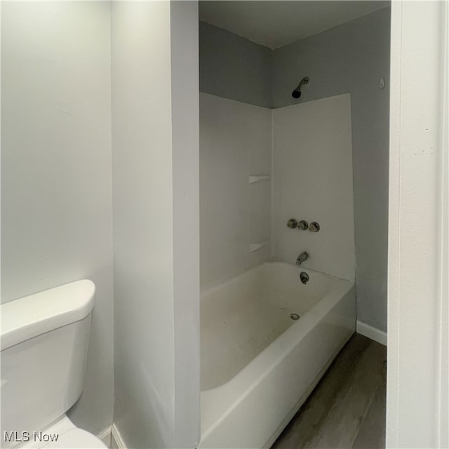 bathroom with toilet, tub / shower combination, and wood-type flooring