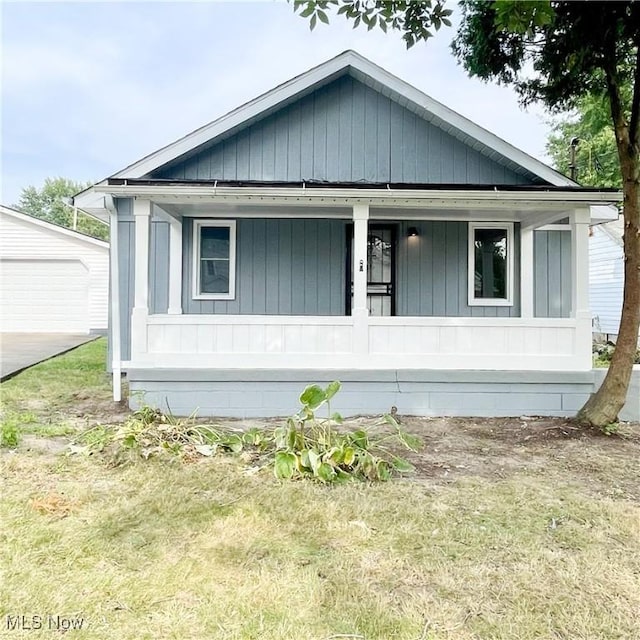 exterior space with a porch and an outbuilding