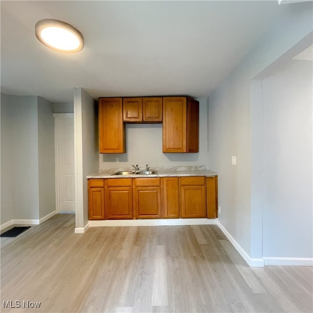 kitchen with light hardwood / wood-style floors and sink