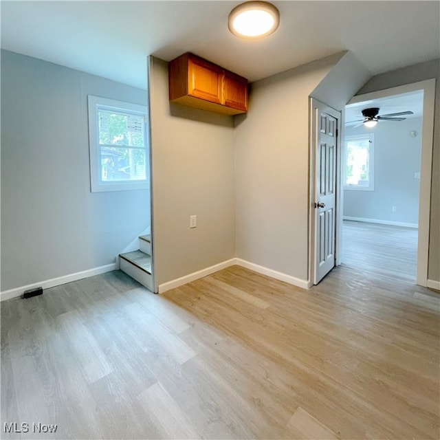 unfurnished room featuring ceiling fan, light hardwood / wood-style flooring, and a healthy amount of sunlight