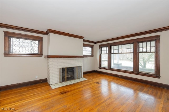 2572-2574 Mayfield Rd, Cleveland Heights, OH 44106 - unfurnished living room featuring ornamental molding, wood finished floors, and a fireplace