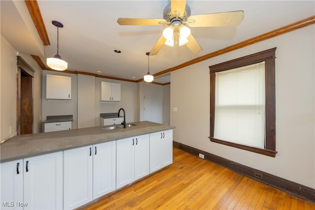 2572-2574 Mayfield Rd, Cleveland Heights, OH 44106 - kitchen with white cabinetry, light wood-style floors, crown molding, and decorative light fixtures